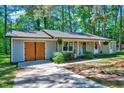 Well-kept single-story home with an attached garage and a neatly manicured front lawn at 9220 Old Cascade Dr, Garner, NC 27529