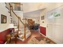 Inviting foyer with hardwood floors, staircase, and dining room view, creating a warm entry at 9408 Bells Valley Dr, Raleigh, NC 27617