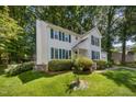 Well-maintained two-story home with green lawn, showcasing the yard with landscaping at 9408 Bells Valley Dr, Raleigh, NC 27617