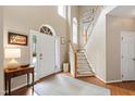 Bright foyer with hardwood floors, a staircase, and a view to the front door at 9517 Candor Oaks Dr, Raleigh, NC 27615