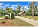 Exterior view of the home showcasing the rooflines, garage, and surrounding foliage at 1003 W Divine St, Dunn, NC 28334