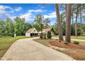 View of the home's exterior with a long driveway leading up to the house and garage at 1003 W Divine St, Dunn, NC 28334