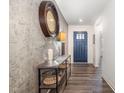 Inviting foyer features stylish decor, a unique accent wall, and wood-look flooring at 1012 Ringhill Bluff Dr, Durham, NC 27704