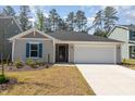 Inviting single-story home boasts a neat front yard and attached two-car garage at 1012 Ringhill Bluff Dr, Durham, NC 27704