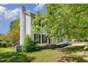 View of a well-maintained two-story home featuring a classic design with a chimney and landscaped yard at 105 Hiddenwood Ct, Garner, NC 27529
