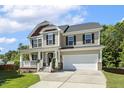 Charming two-story home featuring a welcoming front porch and well-maintained landscaping at 109 Lyngrove St, Holly Springs, NC 27540