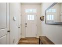 Bright entryway features wood flooring, a bench, and a mirror at 1101 Compass Dr, Durham, NC 27713