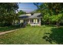 Traditional home with a covered front porch, dormer windows, and a well-manicured lawn at 1111 College St, Oxford, NC 27565