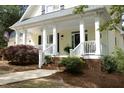 Inviting front porch with classic white columns and charming brick-lined steps at 1605 Heritage Club Ave, Wake Forest, NC 27587
