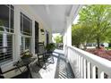 Covered front porch features a comfortable seating area at 1605 Heritage Club Ave, Wake Forest, NC 27587