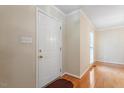 Bright entryway featuring hardwood floors, a neutral color palette, and a white door at 1614 Finnsbury Dr, Burlington, NC 27217