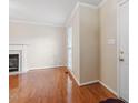 Inviting living room featuring hardwood floors, a fireplace, and crown molding at 1614 Finnsbury Dr, Burlington, NC 27217