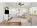 Bright living room with a ceiling fan, a large sectional couch and a decorative rug at 19 Cecina Ct, Clayton, NC 27527