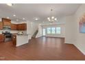 Spacious living area showcasing wood floors, modern lighting, and an open floor plan leading to the kitchen at 1904 Birdhouse Ln, Wake Forest, NC 27587
