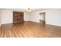 Open-concept living room boasts a brick fireplace and leads to other parts of the home at 201 E Laramie Dr, Mebane, NC 27302