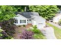An aerial view of a charming home with a well-manicured lawn and a driveway leading to the garage at 203 Needle Park Dr, Cary, NC 27513