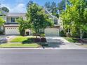 Well-maintained home boasts a stone facade, two-car garage, and lush green lawn at 205 Hammond Wood Pl, Morrisville, NC 27560