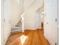 Bright foyer with hardwood floors, a carpeted staircase, and an open layout at 205 Hammond Wood Pl, Morrisville, NC 27560