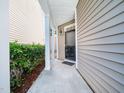 Inviting front porch with classic columns and a black front door, perfect for welcoming guests at 205 Hammond Wood Pl, Morrisville, NC 27560