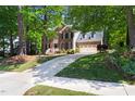 Traditional brick home exterior featuring a driveway, two-car garage and lush front lawn at 206 Kettlebridge Dr, Cary, NC 27511