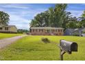Traditional brick home featuring a large green lawn and mailbox at 207 Mcleod Dr, Sanford, NC 27330