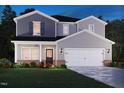 New two-story home exterior boasts a gray color scheme, brick accents, and a two-car garage at 2238 Cherry Creek Rd, Haw River, NC 27258