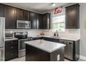 Modern kitchen featuring stainless steel appliances, white subway tile backsplash, and a center island at 2605 Mcdougall Dr, Burlington, NC 27217