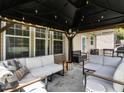 Inviting covered patio with comfortable seating, stylish decor, and a relaxing outdoor ambiance at 2605 Mcdougall Dr, Burlington, NC 27217