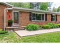 Inviting front entrance showcasing a brick facade, decorative door, and well-manicured landscaping at 2824 Blanche Dr, Burlington, NC 27215