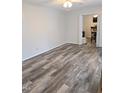 Open living room featuring laminate wood flooring, ceiling fan, and an adjacent dining area at 2824 Blanche Dr, Burlington, NC 27215