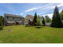 Large backyard featuring a playset, shade sail, and green lawn at 310 Seymour Pl, Cary, NC 27519