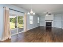 Bright living room with hardwood floors, fireplace, and sliding glass door at 310 Seymour Pl, Cary, NC 27519