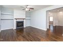 Living room featuring hardwood floors, a fireplace and built in shelving at 310 Seymour Pl, Cary, NC 27519