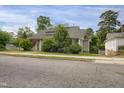 A view of the property highlighting the charming home, landscape, and neighboring buildings at 312 Green St, Sanford, NC 27330