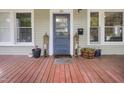 A welcoming front porch with a charming entrance, potted plants, and a cozy vibe at 312 Green St, Sanford, NC 27330