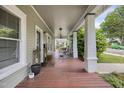 Inviting front porch with wood flooring and white columns, perfect for relaxing outdoors at 312 Green St, Sanford, NC 27330
