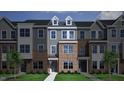 Rendering of a three-unit townhome featuring brick and siding with a gray color palette at 352 Chesapeak Commons St # 136, Garner, NC 27529
