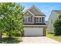 Two-story home featuring a two-car garage and an inviting front yard at 3566 Sunbright Ln, Raleigh, NC 27610