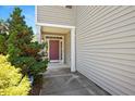 Welcoming front entrance with covered porch and vibrant landscaping at 3566 Sunbright Ln, Raleigh, NC 27610