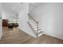 Inviting foyer with wood-look floors, staircase, and views of the living room at 386 The Parks Dr, Pittsboro, NC 27312
