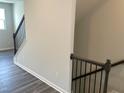 Upstairs view of stairway with gray flooring and black railings at 4004 Silver Oak Ln # 97, Durham, NC 27703