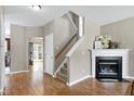 Inviting foyer with hardwood floors, a fireplace, and a staircase leading to the upper level at 4725 Parr Vista Ct, Raleigh, NC 27612