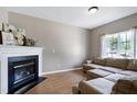 Comfortable living room with a cozy fireplace, neutral walls, and natural light from a large window at 4725 Parr Vista Ct, Raleigh, NC 27612