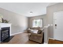 Bright living room with a large sectional sofa, fireplace, and an adjacent entrance door at 4725 Parr Vista Ct, Raleigh, NC 27612
