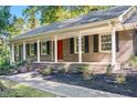 Charming brick ranch-style home with a cozy front porch and well-maintained landscaping at 4901 Old Elizabeth Rd, Raleigh, NC 27616