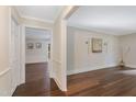 Hallway and living room with hardwood flooring and decorative artwork at 4901 Old Elizabeth Rd, Raleigh, NC 27616