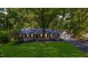 Beautiful single-story brick home with a well-manicured lawn and mature trees at 4901 Old Elizabeth Rd, Raleigh, NC 27616
