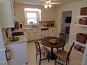 Eat-in kitchen featuring bright cabinets and a window over the sink at 4908 Mandel Rd, Durham, NC 27712
