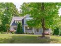 Traditional home featuring a covered front porch and beautifully landscaped front yard at 6509 Duncans Creek Ct, Fuquay Varina, NC 27526