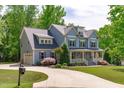 Attractive exterior showcasing a two-story home with attached garage, long driveway, and landscaped yard at 6509 Duncans Creek Ct, Fuquay Varina, NC 27526